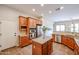 Open concept kitchen with an island and wood cabinets at 25995 N 85Th Dr, Peoria, AZ 85383