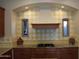 Kitchen detail showcasing diamond-patterned backsplash and granite counters at 25995 N 85Th Dr, Peoria, AZ 85383