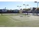 Outdoor tennis court with green turf and lights at 5735 E Mcdowell Rd # 7, Mesa, AZ 85215