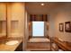 Relaxing bathroom with soaking tub and a window with a custom blind at 10040 E Happy Valley Rd # 504, Scottsdale, AZ 85255
