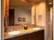 Double vanity bathroom with a large mirror and decorative tile work at 10040 E Happy Valley Rd # 504, Scottsdale, AZ 85255