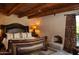 Large bedroom with fireplace and comfortable king-size bed with leather headboard at 10040 E Happy Valley Rd # 504, Scottsdale, AZ 85255