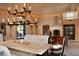 Elegant dining room featuring a large table, chandelier, and comfortable seating at 10040 E Happy Valley Rd # 504, Scottsdale, AZ 85255