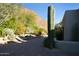 Brick driveway with desert landscaping; large saguaro cactus in foreground at 10040 E Happy Valley Rd # 504, Scottsdale, AZ 85255