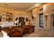 Spacious living room featuring leather armchairs and a large chandelier at 10040 E Happy Valley Rd # 504, Scottsdale, AZ 85255