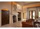 Spacious living room with a fireplace, leather seating, and large windows at 10040 E Happy Valley Rd # 504, Scottsdale, AZ 85255