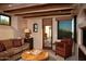 Cozy living room with a wood-burning fireplace, and access to the patio at 10040 E Happy Valley Rd # 504, Scottsdale, AZ 85255