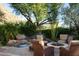 Fire pit and seating area; flagstone patio with desert landscaping at 10040 E Happy Valley Rd # 504, Scottsdale, AZ 85255