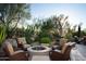 Fire pit and seating area; flagstone patio with desert landscaping at 10040 E Happy Valley Rd # 504, Scottsdale, AZ 85255