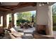 Relaxing patio with fireplace and seating area; view of outdoor dining space at 10040 E Happy Valley Rd # 504, Scottsdale, AZ 85255