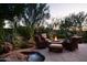Fire pit and seating area; flagstone patio with desert landscaping at 10040 E Happy Valley Rd # 504, Scottsdale, AZ 85255