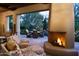 Relaxing patio with fireplace and seating area; view of outdoor dining space at 10040 E Happy Valley Rd # 504, Scottsdale, AZ 85255