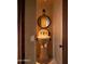 Elegant powder room with a pedestal sink and a round mirror at 10040 E Happy Valley Rd # 504, Scottsdale, AZ 85255