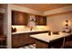 Well-equipped wet bar with granite countertops and custom cabinetry at 10040 E Happy Valley Rd # 504, Scottsdale, AZ 85255