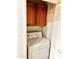 Stackable laundry closet with wood cabinets at 1445 E Broadway Rd # 120, Tempe, AZ 85282