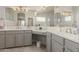 Bathroom with dual vanities, a large mirror, and a walk-in shower at 25714 N 70Th Ln, Peoria, AZ 85383