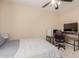 Bright bedroom with a comfy bed, desk, and TV at 25714 N 70Th Ln, Peoria, AZ 85383