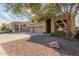 Two-story house with three-car garage, tree, and rock landscaping at 25714 N 70Th Ln, Peoria, AZ 85383
