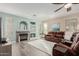 Cozy living room with a fireplace and hardwood floors at 25714 N 70Th Ln, Peoria, AZ 85383