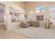 Open living room with high ceilings, a sofa, and a view to the dining room at 25714 N 70Th Ln, Peoria, AZ 85383