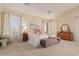 Bright main bedroom with high ceilings and plush bedding at 25714 N 70Th Ln, Peoria, AZ 85383
