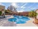 Inviting kidney-shaped pool with a large patio area at 25714 N 70Th Ln, Peoria, AZ 85383