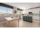 Modern kitchen with white cabinets, granite countertops, and a large island at 25714 N 70Th Ln, Peoria, AZ 85383