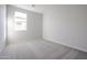 Well-lit bedroom featuring carpet flooring and a window at 39995 W Bravo Dr, Maricopa, AZ 85138