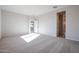 Spacious bedroom with carpet flooring and access to bathroom at 39995 W Bravo Dr, Maricopa, AZ 85138