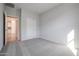 Bright bedroom with carpet flooring and access to a bathroom at 39995 W Bravo Dr, Maricopa, AZ 85138
