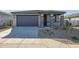 One-story house with gray exterior, two-car garage, and small front yard at 39995 W Bravo Dr, Maricopa, AZ 85138