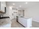Modern kitchen with white cabinets, granite countertops, and stainless steel appliances at 39995 W Bravo Dr, Maricopa, AZ 85138