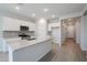 Modern kitchen with white cabinets, granite countertops, and stainless steel appliances at 39995 W Bravo Dr, Maricopa, AZ 85138
