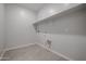 Laundry room with shelving and tile flooring at 39995 W Bravo Dr, Maricopa, AZ 85138