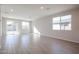 Bright and airy living room with tile floors and multiple windows at 39995 W Bravo Dr, Maricopa, AZ 85138
