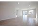 Open living area with tile floors and sliding glass door at 39995 W Bravo Dr, Maricopa, AZ 85138