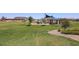Green grassy park with shaded seating and playground at 39995 W Bravo Dr, Maricopa, AZ 85138