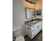 Bathroom with vanity, toilet and a large mirror above the sink at 4237 E 4Th Ave, Apache Junction, AZ 85119