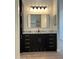 Elegant bathroom, featuring a dark vanity, granite countertop and a large mirror at 4237 E 4Th Ave, Apache Junction, AZ 85119