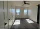Spacious bedroom with two windows, wood flooring, and a ceiling fan at 4237 E 4Th Ave, Apache Junction, AZ 85119