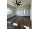 Spacious bedroom with wood-look flooring, large windows, and access to a private patio at 4237 E 4Th Ave, Apache Junction, AZ 85119
