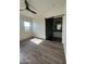 Bright bedroom with wood flooring, a ceiling fan, and a barn door at 4237 E 4Th Ave, Apache Junction, AZ 85119