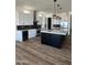 Modern kitchen with white cabinets, marble countertops, and a large island at 4237 E 4Th Ave, Apache Junction, AZ 85119