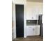 White kitchen cabinets and pantry with geometric backsplash at 4237 E 4Th Ave, Apache Junction, AZ 85119
