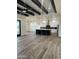Open concept kitchen with wood-look floors and exposed beams at 4237 E 4Th Ave, Apache Junction, AZ 85119