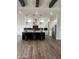 Modern kitchen with large island, white cabinets, and wood flooring at 4237 E 4Th Ave, Apache Junction, AZ 85119