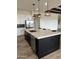 Modern kitchen island with white cabinets, quartz countertop, and stainless steel appliances at 4237 E 4Th Ave, Apache Junction, AZ 85119