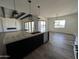 Open concept kitchen with island, exposed beams, and Gathering room view at 4237 E 4Th Ave, Apache Junction, AZ 85119