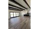 Open living area with exposed beams, hardwood floors, and sliding doors at 4237 E 4Th Ave, Apache Junction, AZ 85119