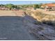 Sloped lot with rocky terrain and distant neighborhood views at 4237 E 4Th Ave, Apache Junction, AZ 85119